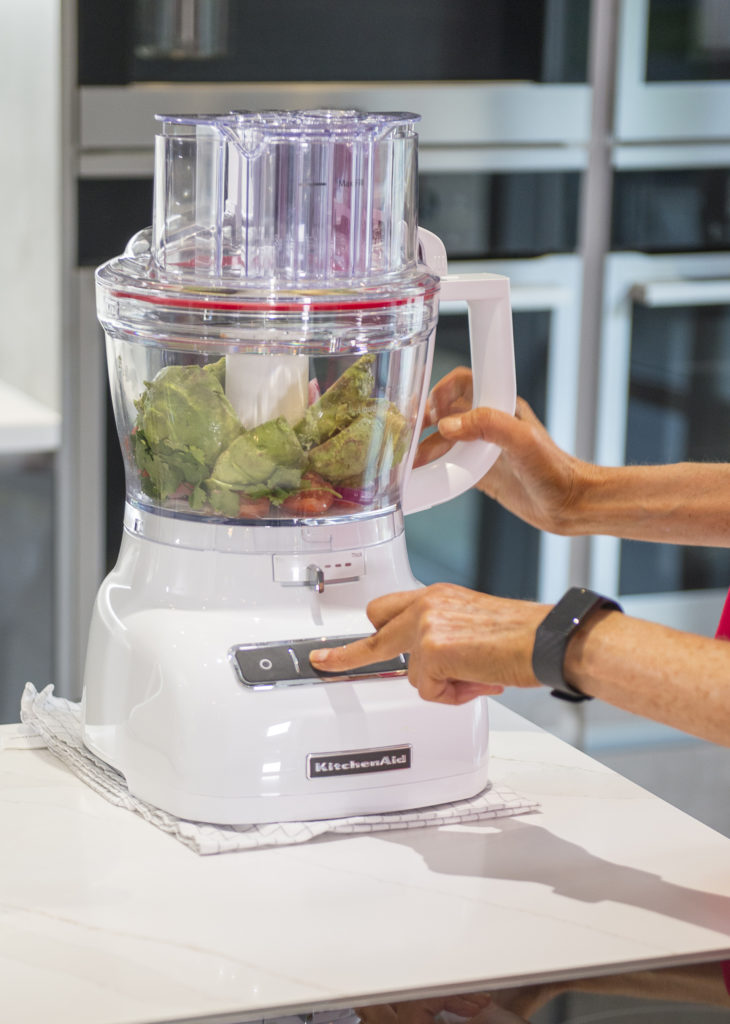 Place the chopped avocados and tomatoes into a food processor with the juice of the lime, chopped red onion and deseeded and chopped chilli and pulse.