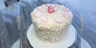 Layered coconut and raspberry cake recipe by home cooking with julie neville